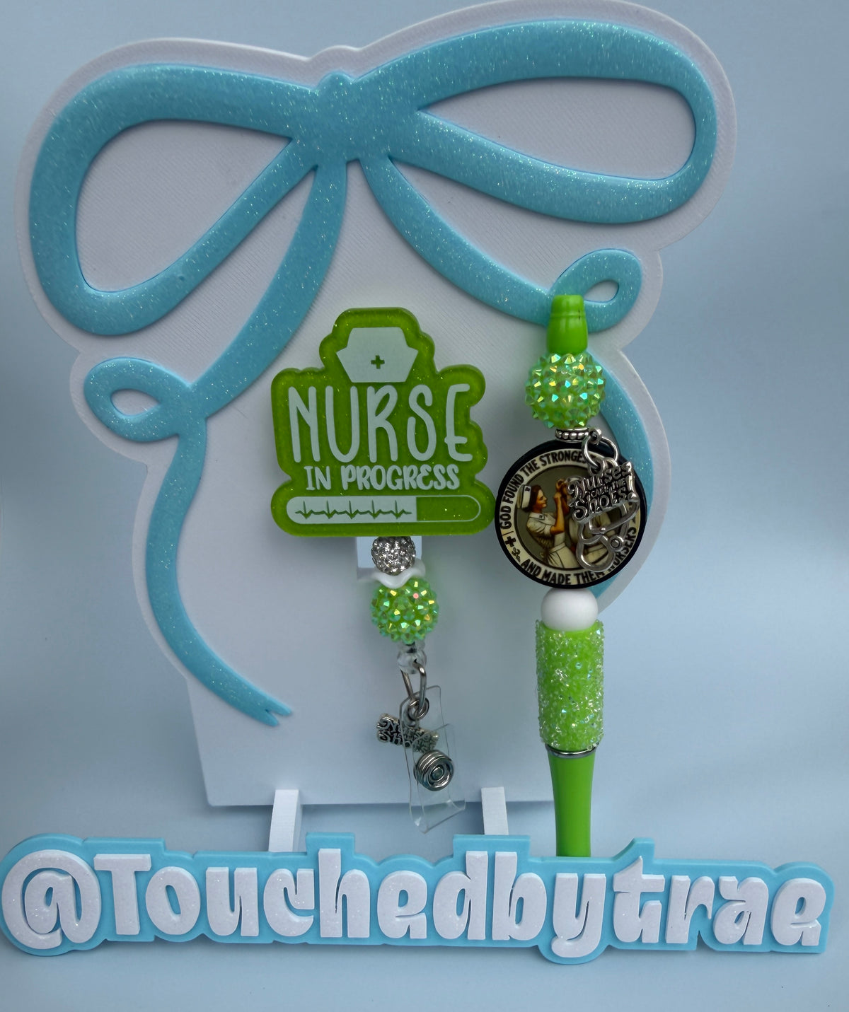 Green and white nurse in progress badge reel and pen combo