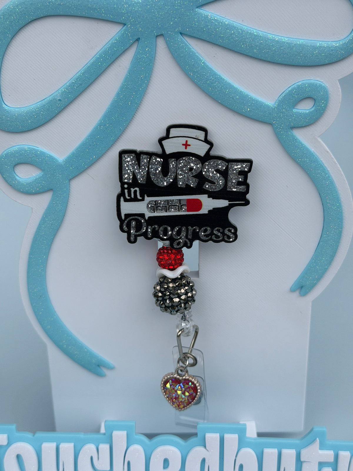 Nurse in progress badge reel, red black and white