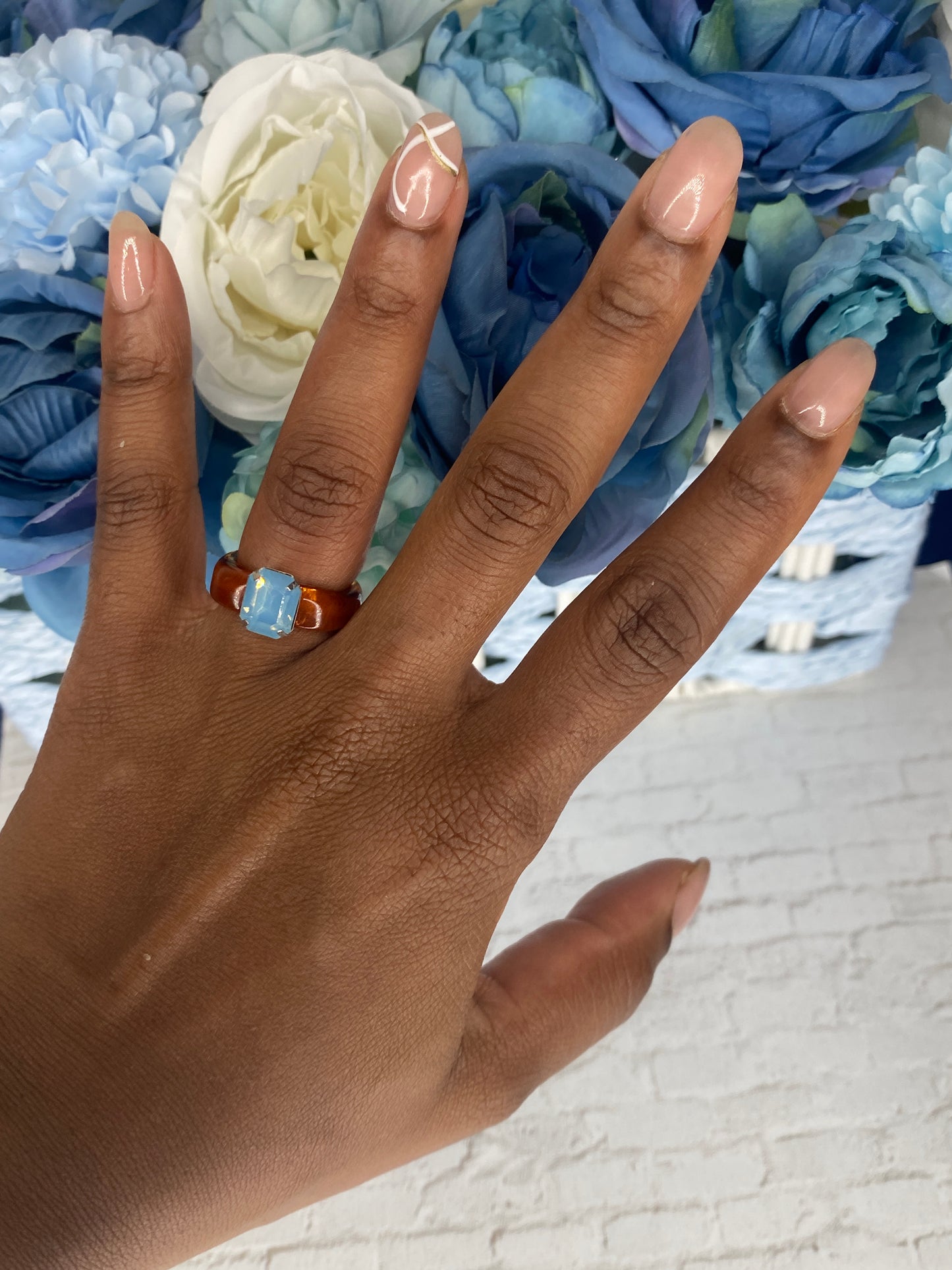 Brown acrylic ring with light blue stone