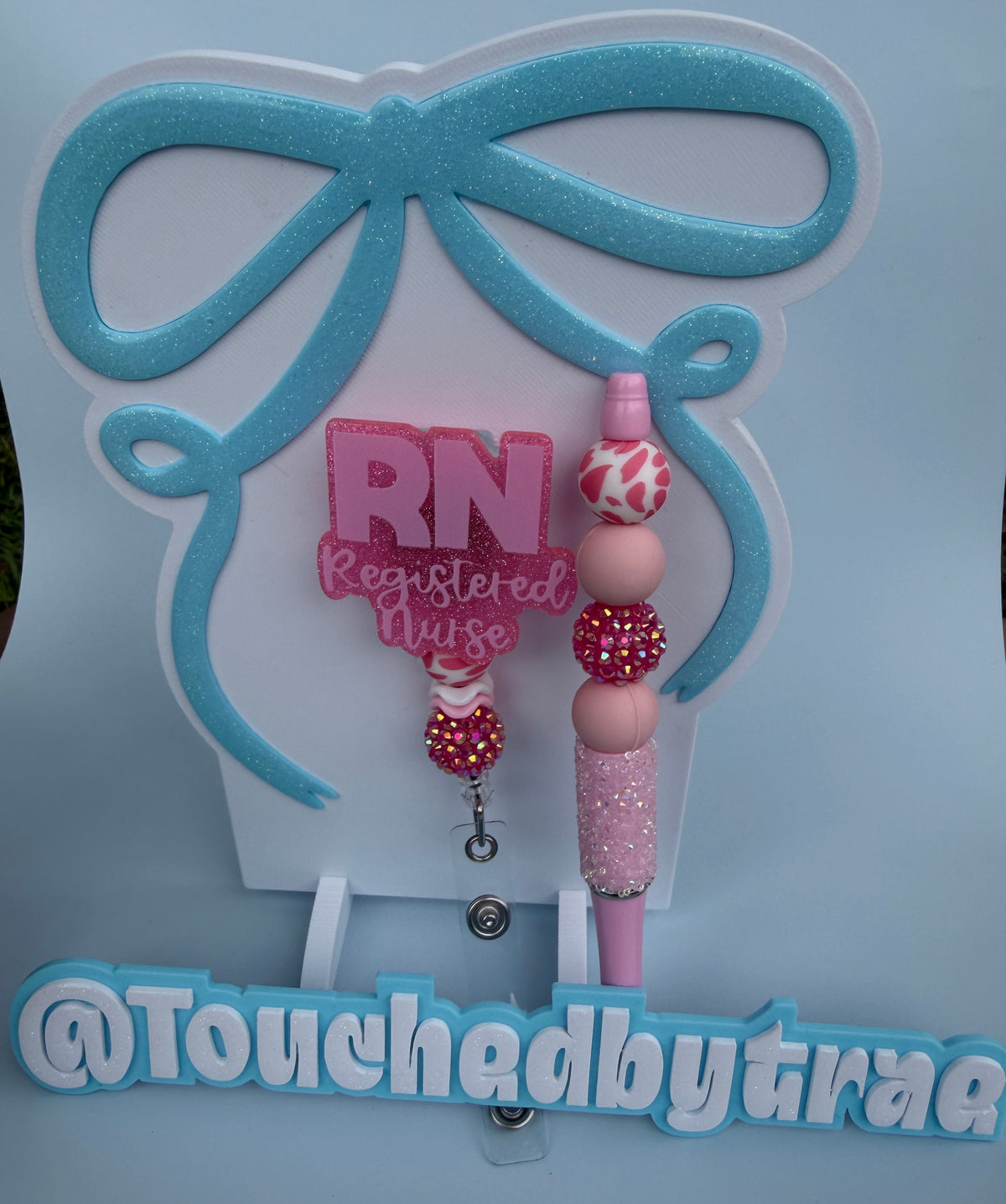 Pink rn badge reel and pen
